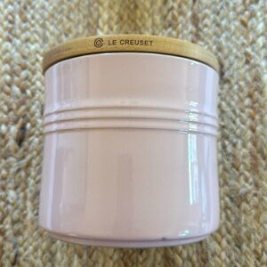 Le Creuset chiffon pink small canister with a wood top